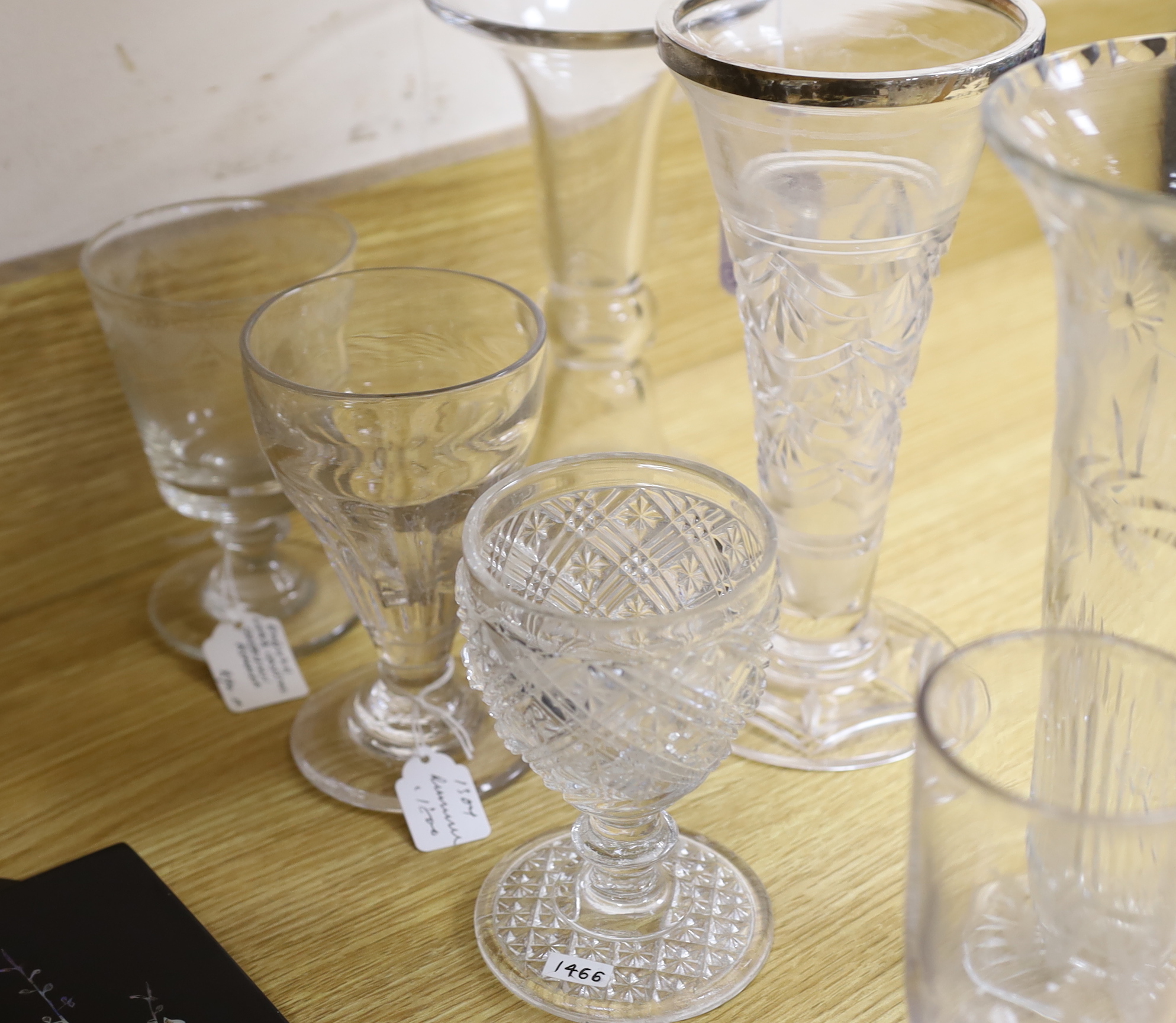 A collection of 18th and 19th century drinking glasses, etc. including rummers, engraved sherry glasses with knobbed stems, folded feet and broken pontils, a cut glass goblet, a Georgian finger bowl and stand, two vases,